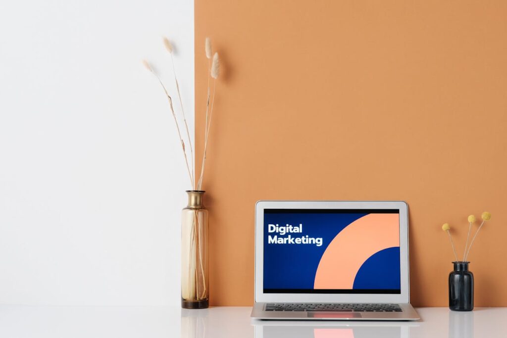 PLACED A LAPTOP ON A TABLE ON THE SCREEN WRITTEN DIGITAL MARKETING