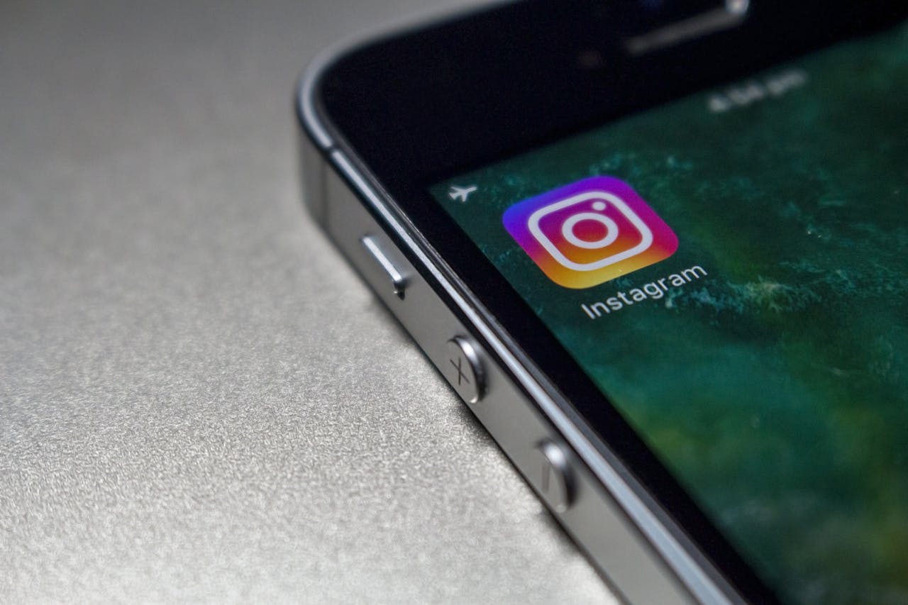 A PHONE PLACED ON A TABLE THAT SHOWS THE INSTAGRAM INTERFACE